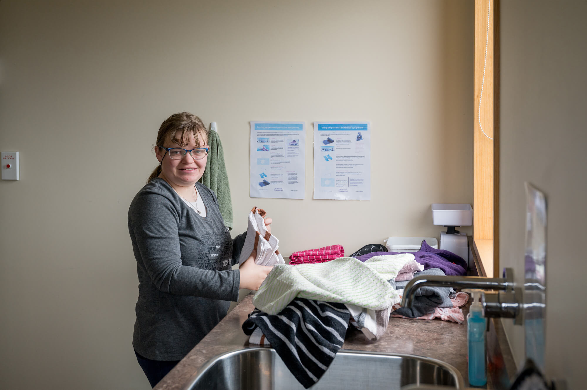 a person folding laundry