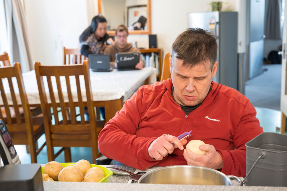 a person peeling potatoes