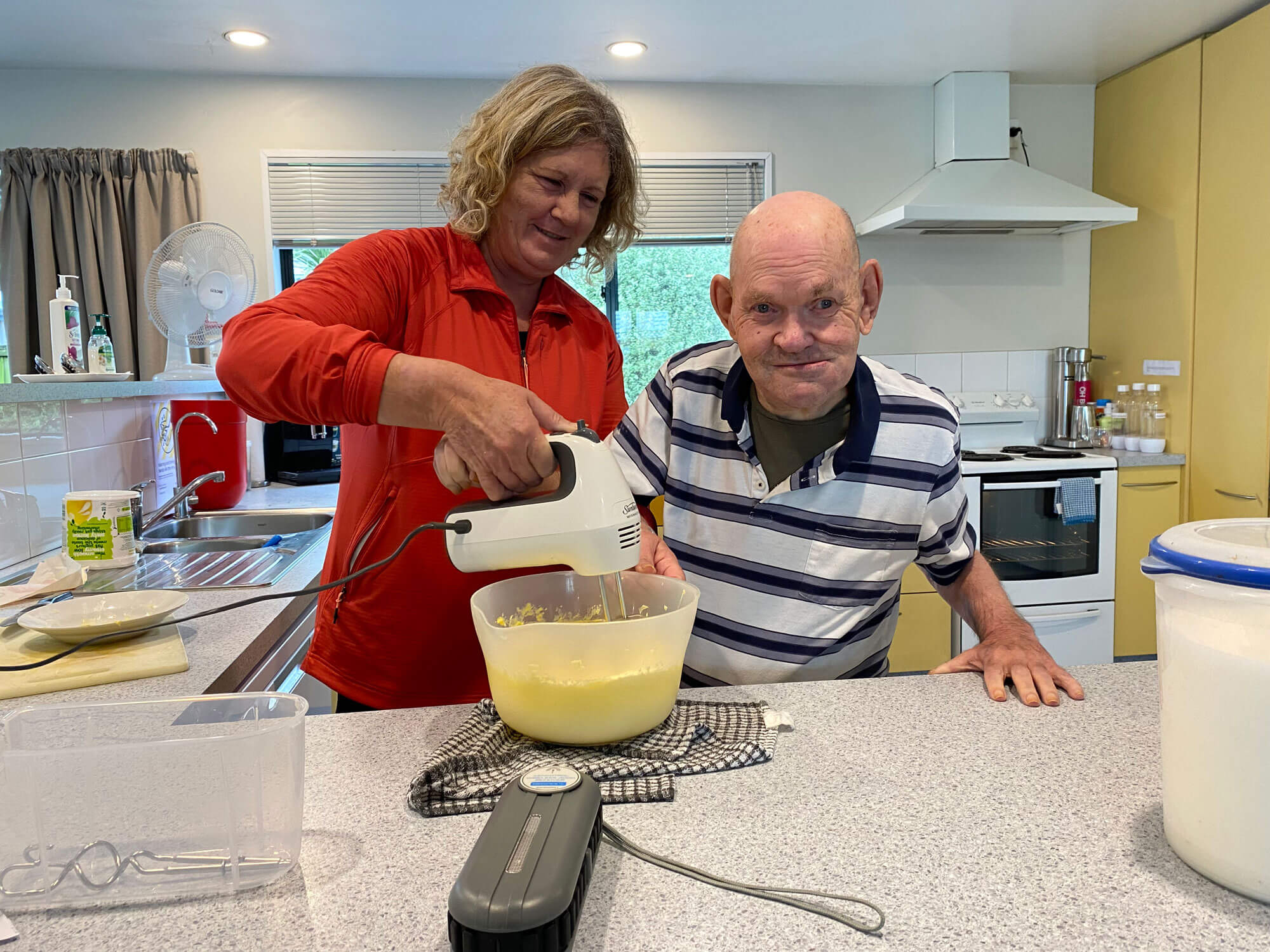 staff member and brian cooking