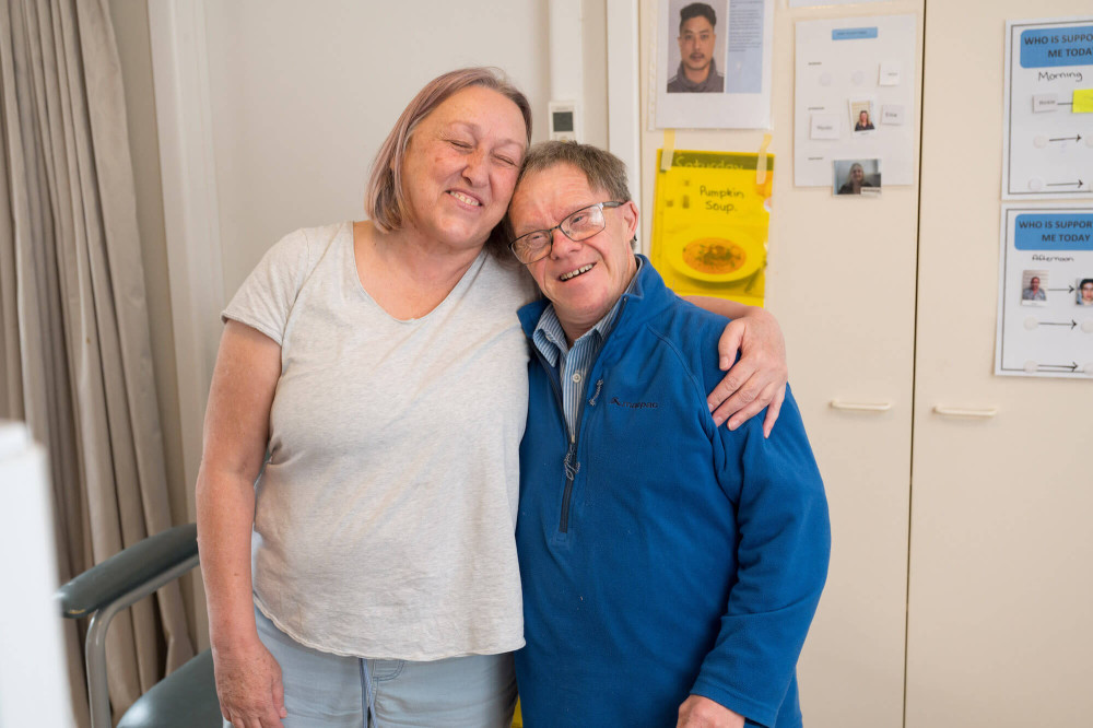 two people hugging and smiling